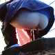 Someone uses a video camera to sneak a peek under a camping tent as an unsuspecting woman takes a piss and a shit into a makeshift latrine in the tent. Although video is 720P, it is rather dark and grainy. Over 2 minutes.